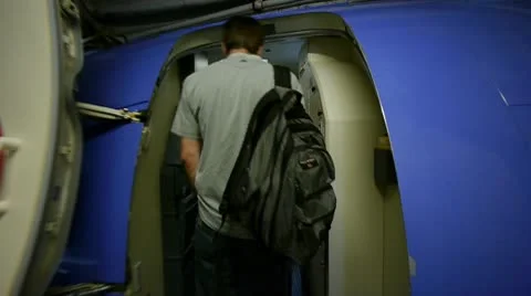 Walking on to plane front door Stock Footage 9026412