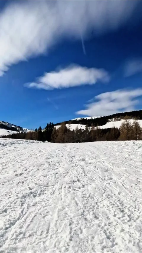 Walking POV foot height while hiking on a snowy mountain on a sunny day Stock Footage 331857755