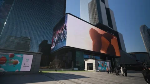 Walking POV of massive curved 3D LED screen at SMTown COEX K-Pop Square Seoul Stock Footage 324694240