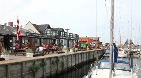 Walking on the quay in front of the restaurants in the harbor Stock-Footage 40686967