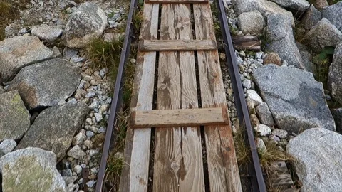 Walking on rails in high mountains Stock Footage 115485860