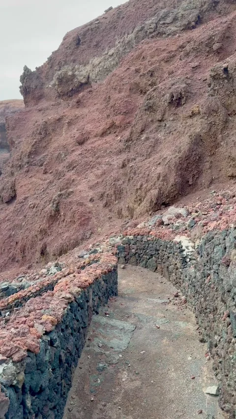 Walking a Red Volcanic Path in Lanzarote Stock Footage 345962623