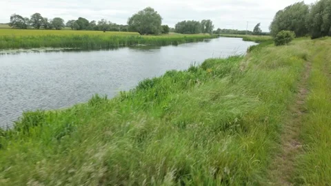 Walking by the River Nene toward a gate, Water Newton Stock Footage 336203103