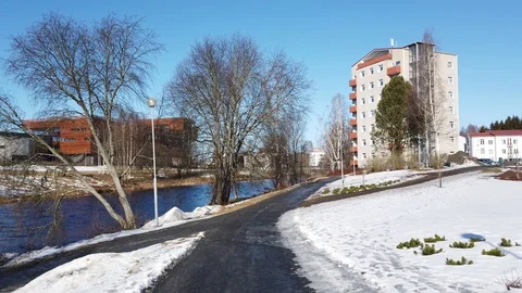 Walking in river side in beautiful spring weather. Snow is melting and sun Stock Footage 105353920