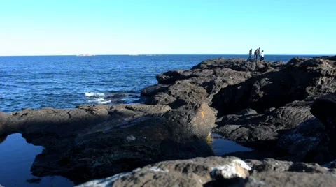 Walking on rock shore Видео 45531599