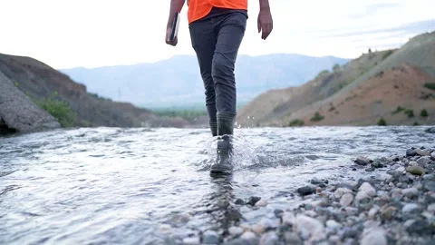 Walking With Rubber Boots in a shallow stream 스톡 동영상 241738503