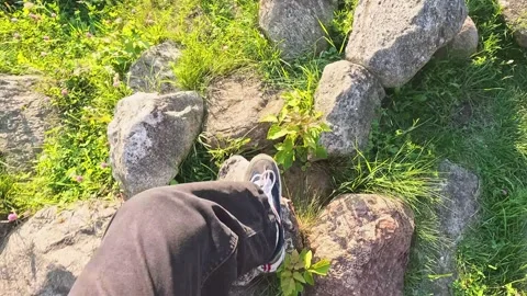 Walking on rugged stones in evening light Stock Footage 314302066