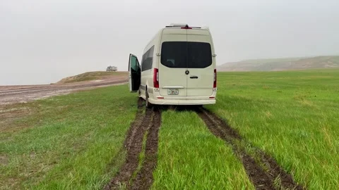 Walking up on a RV Sprinter Van stuck in the mud in the Wall, SD boondockin.. Stock Footage 245176476