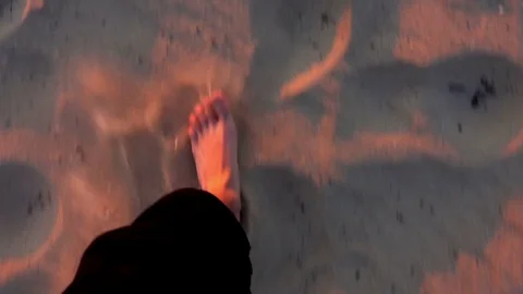 Walking in Sand. Orange Reflection. Sunset. Stockbeeldmateriaal 69740182