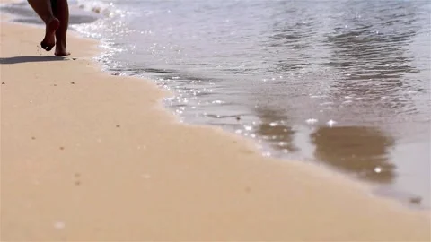 Walking on the Sandy Beach and man's feet Stock Footage 247591322