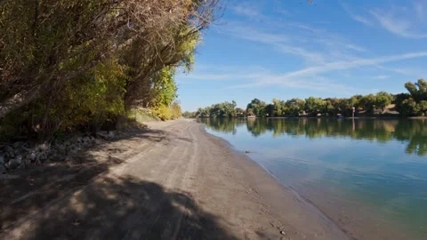 Walking on sandy beach on river fall scene Video stock 296344739