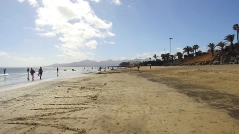 Walking on the sandy white beach in Puerto del Carmen Lanzarote Spain Video stock 88063331