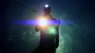 Walking Scientist Holding Flashlight Exploring Dark Ice Cave. Light Beaming Stock Footage