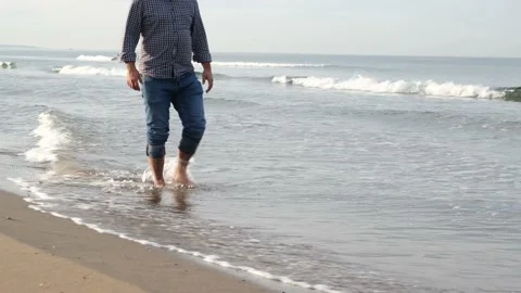 Walking by sea, a middle-aged man walks on the beach in autumn Stock Footage 168653622
