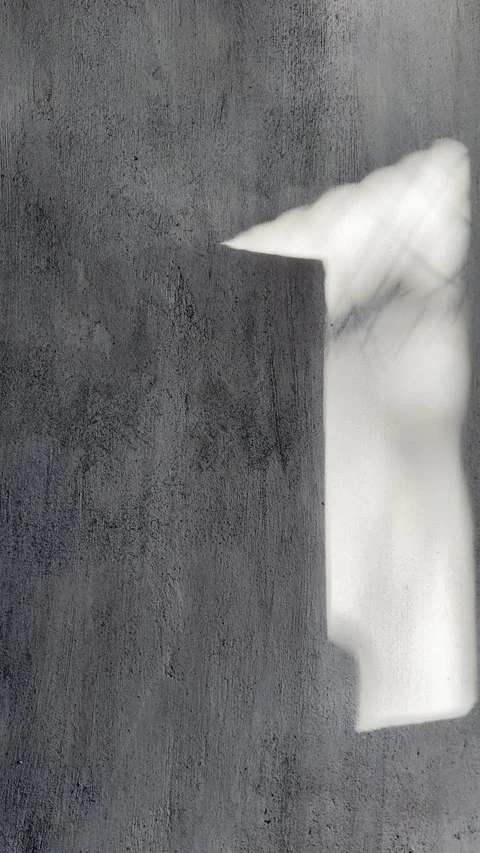 Walking Shadow on Brutalist Wall with Sunlit Window Reflections Vertical Stock Footage 339432796