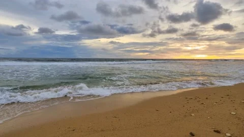 Walking on the side beach to the waves at sunset Stock Footage 166373626