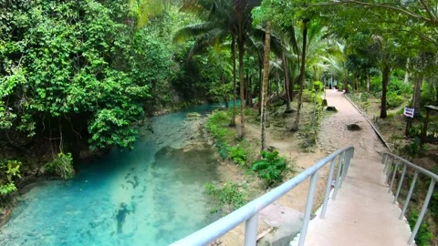 Walking on a small bridge over blue colored river Video stock 150004576