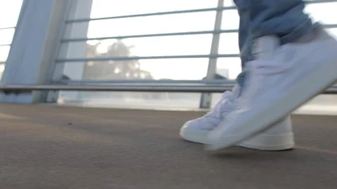 Walking with sneakers Stock Footage 169046734