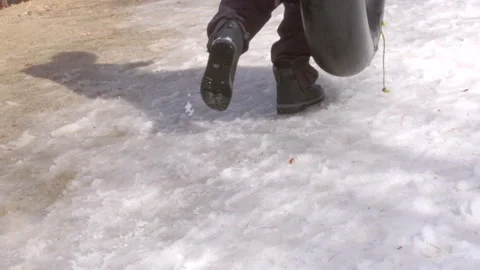 Walking in the snow with boots behind Stock Footage 240975038