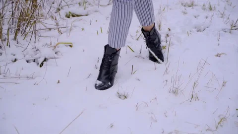 Walking on snow : close-up view of woman's leather shoes and feet. beautiful Stock Footage 83319623