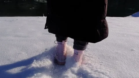 Walking in the snow in slow motion. Close-up of feet walking in the snow in slow Stock-Footage 276507256