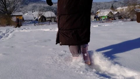 Walking in the snow in slow motion. Close-up of feet walking in the snow in slow Stock-Footage 276507287