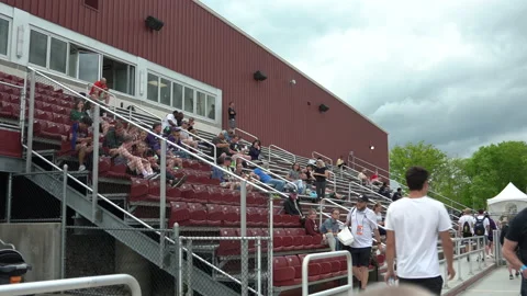 Walking at a stadium in front of bleachers Stock Footage 202092776