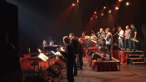 Walking onto stage through stage door, full band playing live on stage 스톡 동영상 101160271