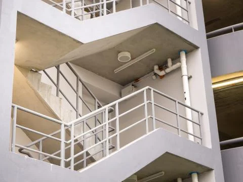 Walking stair on the side of a white multi storey parking lots building Stock Photos