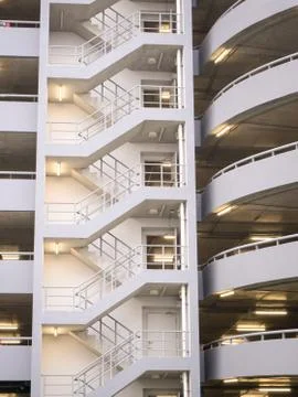 Walking stair on the side of a white multi storey parking lots building Stock Photos