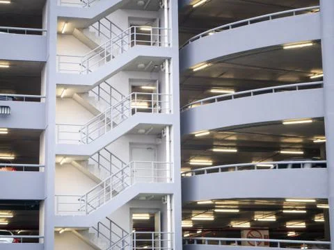 Walking stair on the side of a white multi storey parking lots building Stock Photos