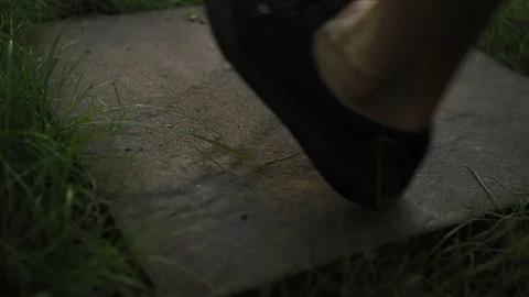 Walking on a stepping stone path in a backyard Stock Footage 98637854