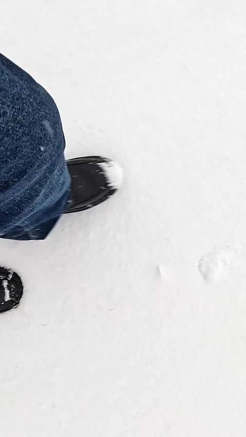 Walking steps on fresh winter snow captured from top-down perspective Stock Footage 322184003
