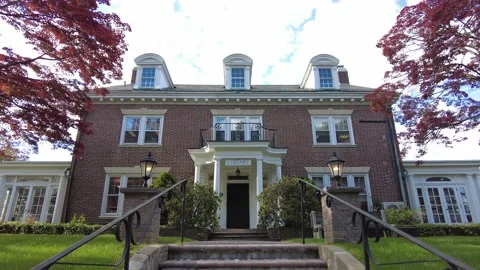 Walking up steps to red brick colonial building Stock Footage 158817433