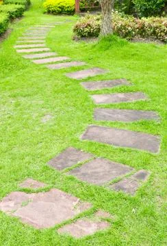 Walking stone on green grass Stock Photos