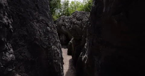Walking a stone path through the Shilin Stone Forest in Kunming Stock Footage 329471531