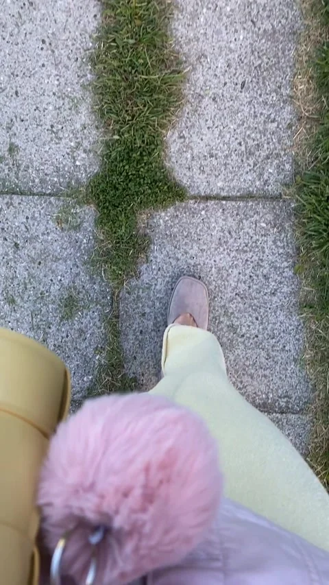 Walking on stone pavement with single step in focus, casual footwear and a .. Stock Footage 312628741