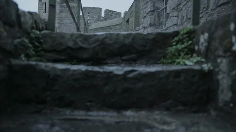 Walking up stone steps of Medieval Castle Stock Footage 128641407