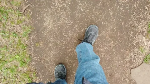 Walking on stones and branches through a nature path. 4K Stock Footage 132645474