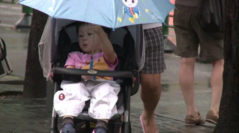 Walking a stroller under the rain in China  Stock Footage 38175590