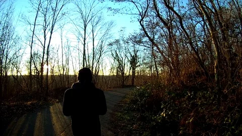 Walking on sunshine behind a person 動画素材 79603182
