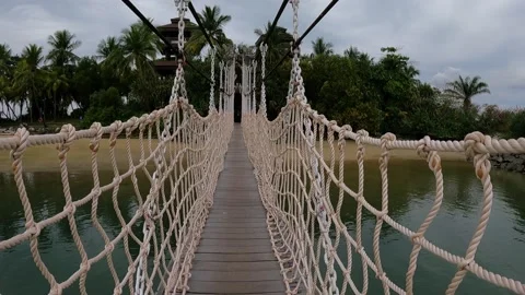 Walking on a suspended bridge on isand Stock Footage 155886884