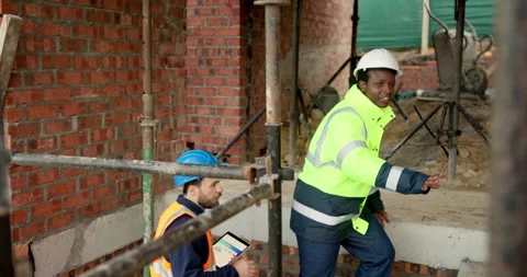 Walking, tablet and construction workers on site for inspection, building or Vídeos de archivo 337631313