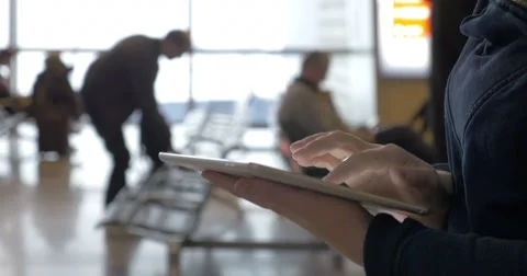 Walking with tablet computer in airport lounge Stock-Footage 51683871