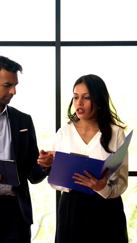 Walking with tablet inside office, Indian businessman discuss project at window Stock Footage 342559778