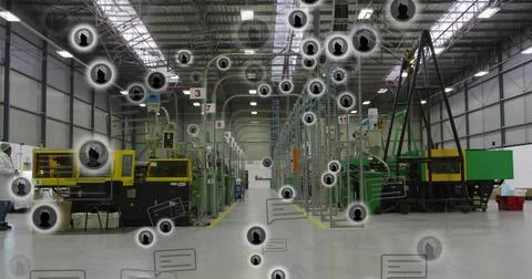 Walking tech wearing white coat and hairnet inspecting molding lines in central Stock Photos
