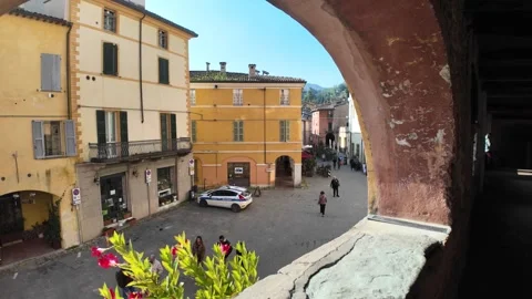Walking through the arched windows of Via degli Asini in Brisighella in Italy Stock Footage 309530990