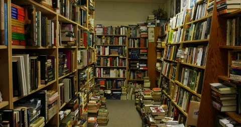 Walking through a bookstore full of old and new books library Stock Footage 232976084