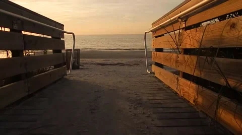Walking through bridge to sunset over beach Vídeos de archivo 45464706