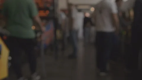 Walking through busy arcade out of focus GRADED Stock Footage 123402576